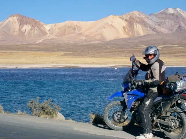 Motorcycle Rider by Lake in Bolivia
