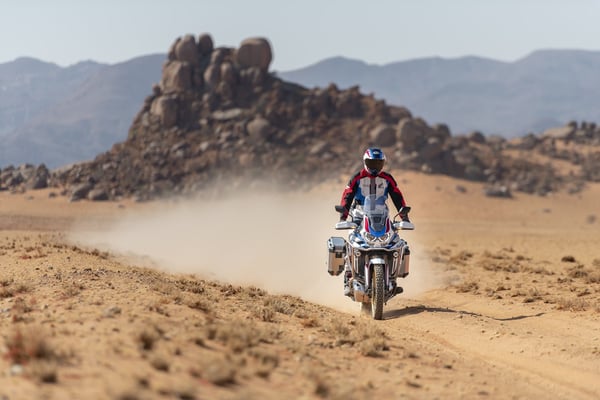 Rider on a brand new 2020 Honda Africa Twin riding through the desert