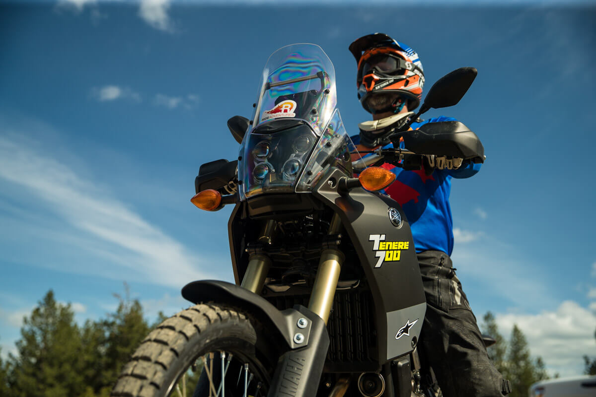 Adventure Motorcycle rider Eric Lange seated on the Tenere 700 from a ground level perspective.