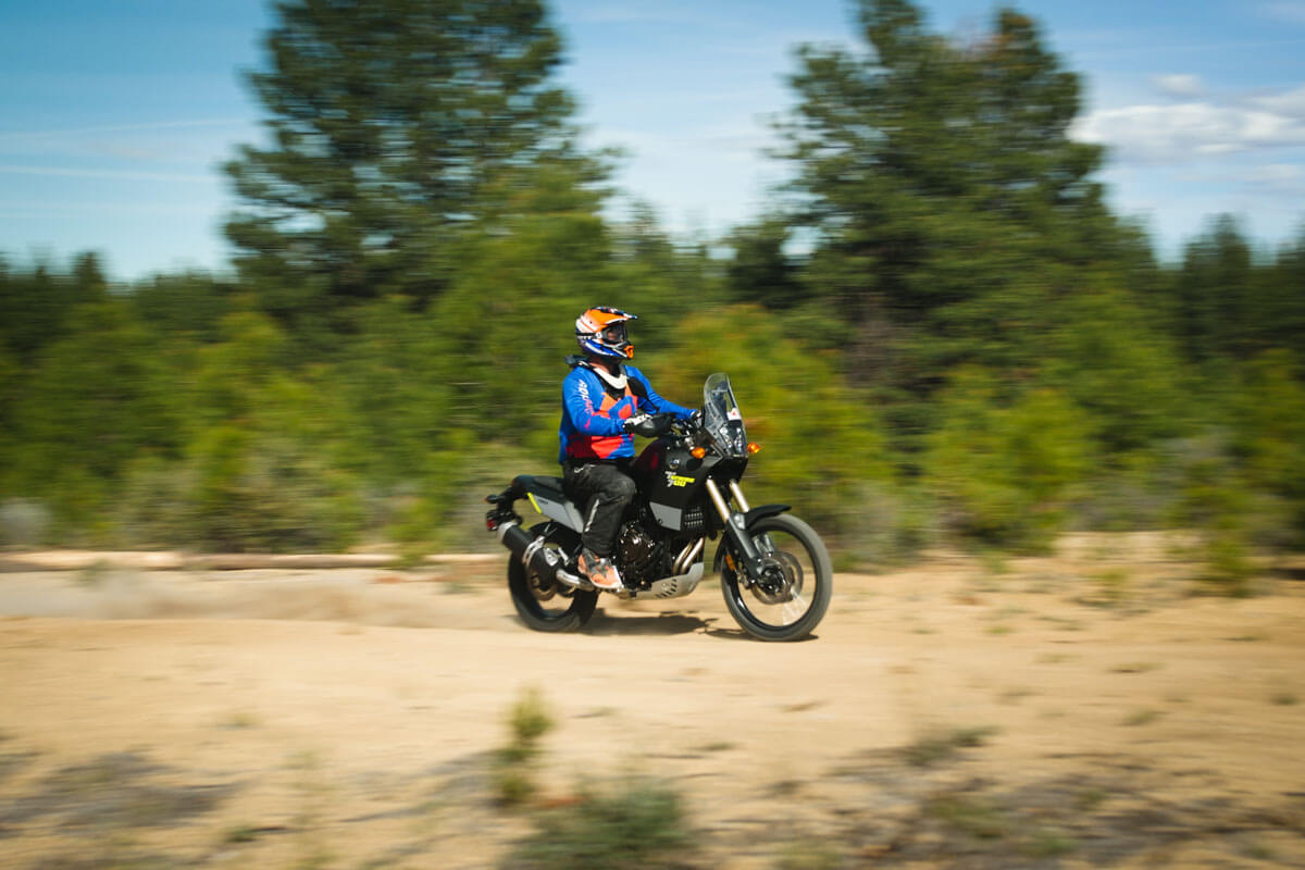 Eric rides the Tenere 700 with a blurry background showing the speed of the bike. 