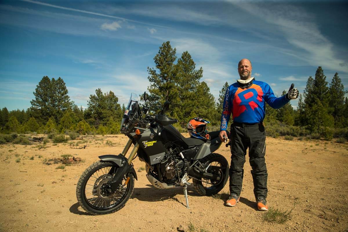 Eric giving a thumbs up next to the Tenere 700 for the pros section of the article.