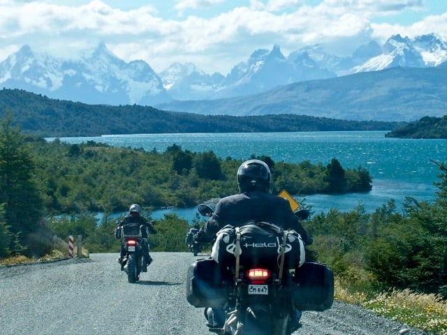 motorcyclists riding while enjoying a view of torres del paine.