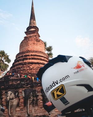 Our Logo and helmet with a Buddhist Temple behind it.