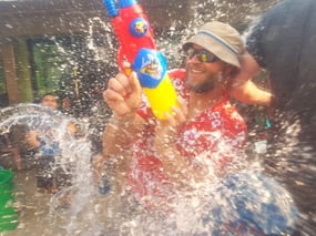 Eric getting shot with waterguns during an epic water battle during Songkran in Thailand