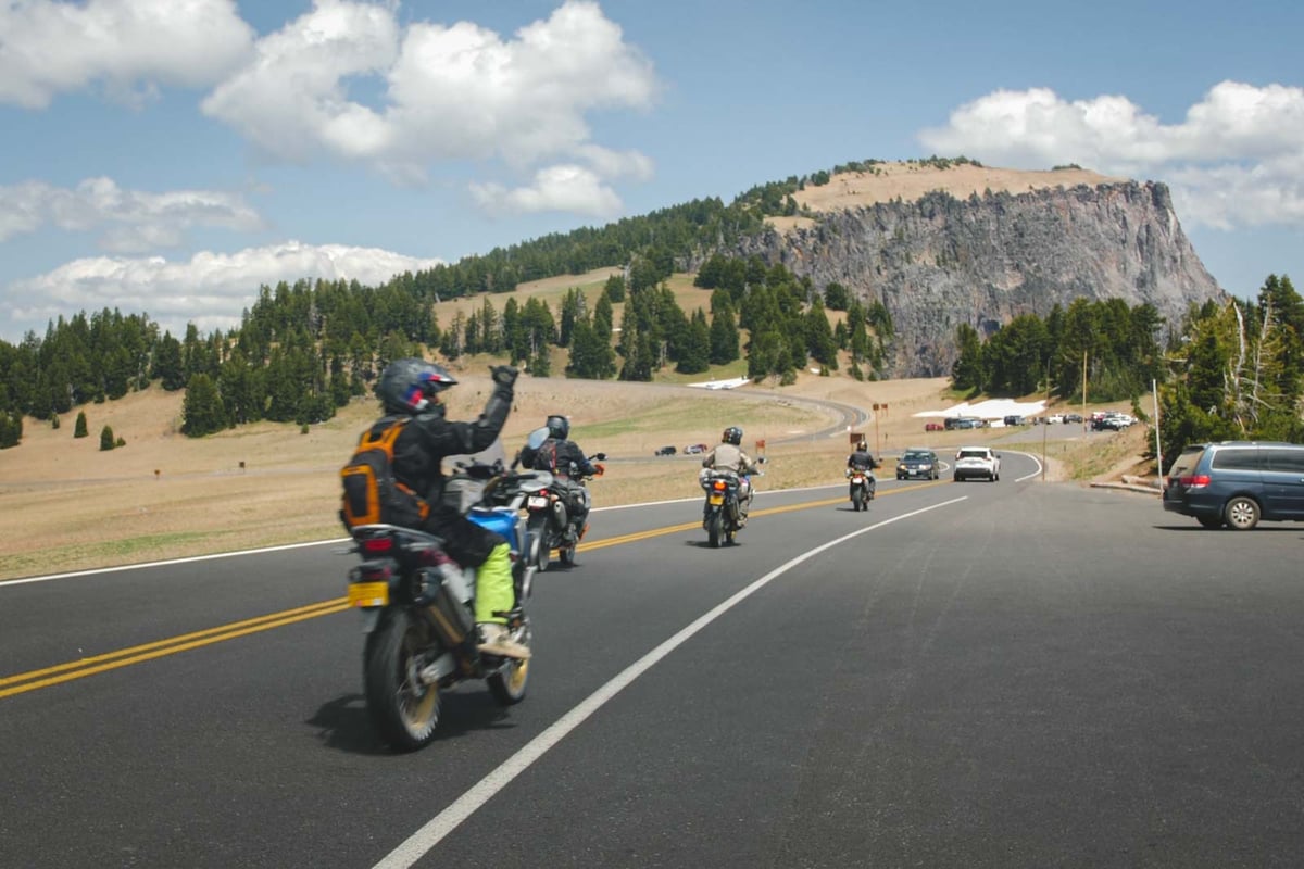 adv-rider-sends-the-shaka-in-crater-lake-national-park-on-adventure-motorcycle-tour-oregon
