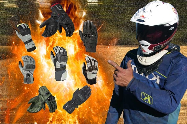 Eric pointing at all the adventure motorcycle gloves floating next to him in a ball of fire.