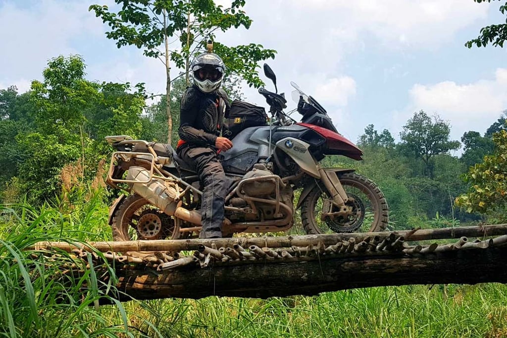 Dermot stops for a photo on a bamboo bridge in Thailand
