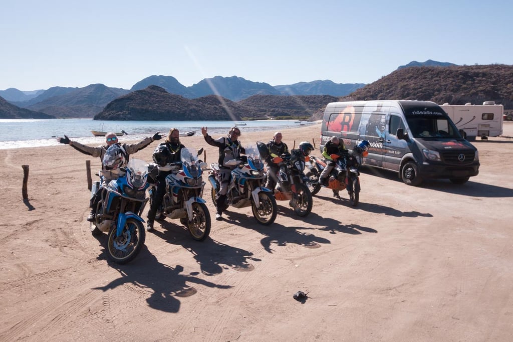Row of ADV riders cheering while on our Baja tour.