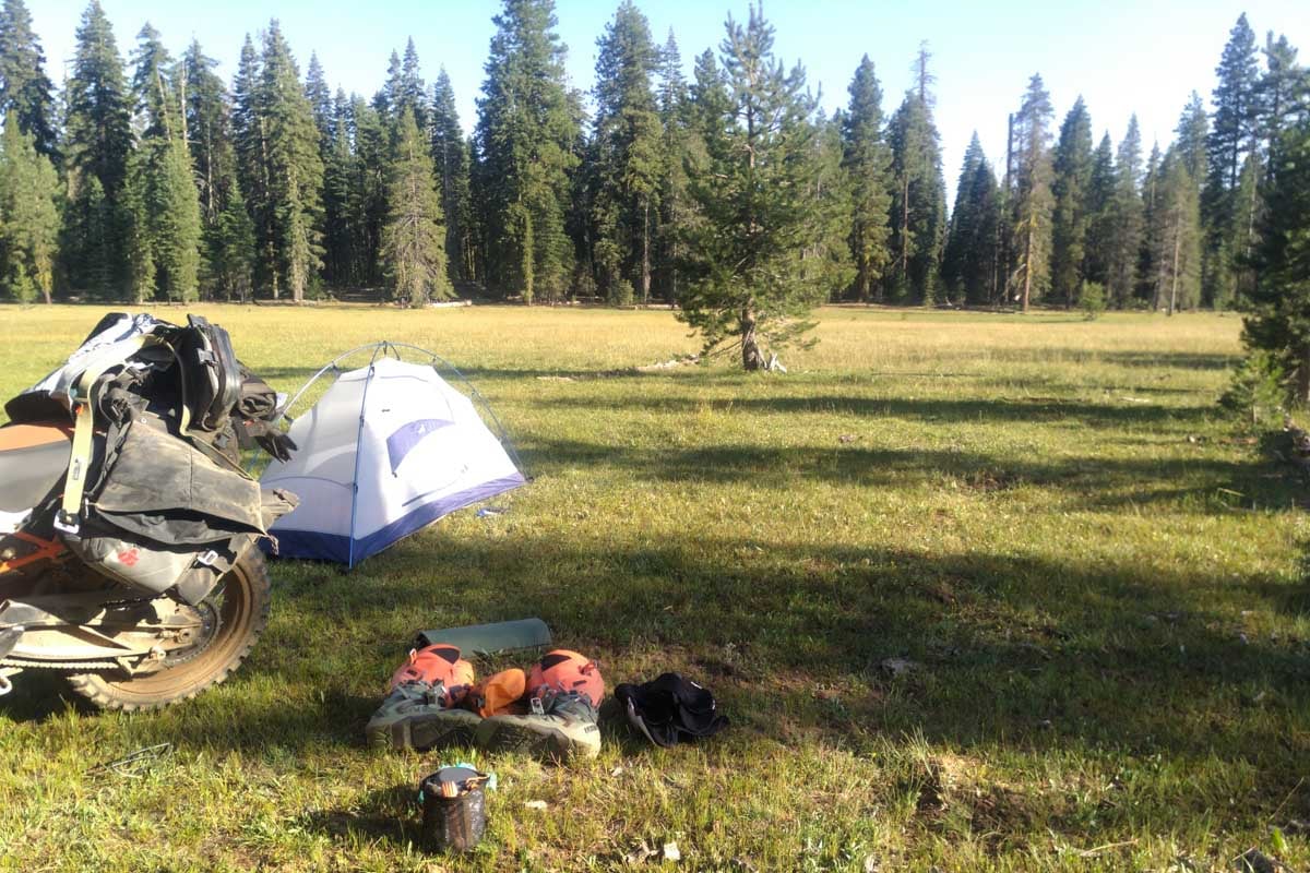 campsite tent set up with gear and bike on the norcal or oregon bdr