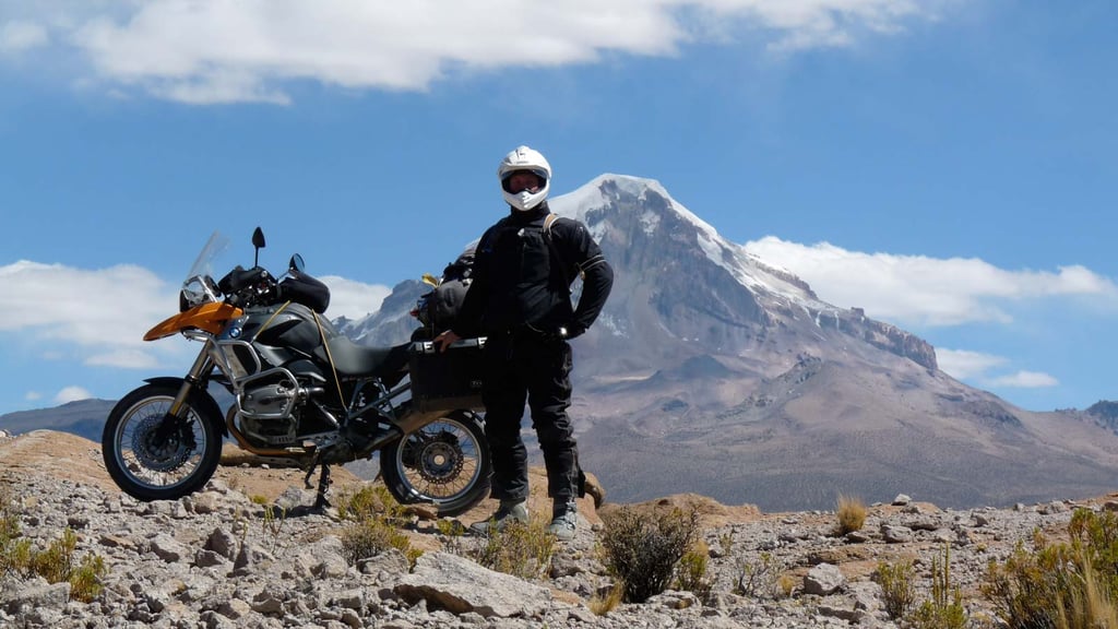 Eric posing in front of a mountain in Bolivia.