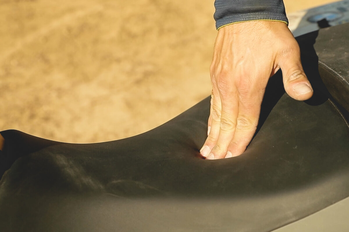 Eric pushes down on Corbin aftermarket seat for adventure motorcycles.