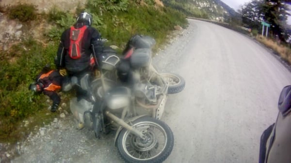 A few guys on our adventure motorcycle tour in Bolivia get pinned by their hard motorcycle cases after crashing