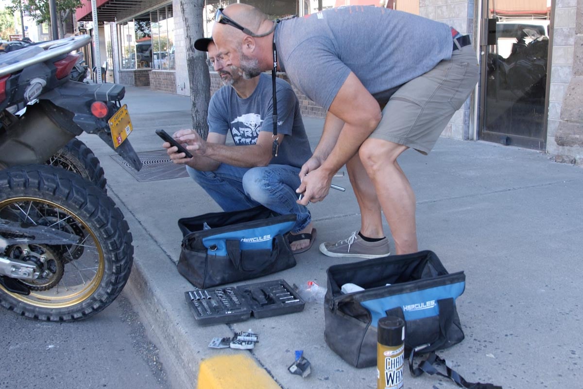 Eric using his own toolkits to maintain the motorcycles on tour.