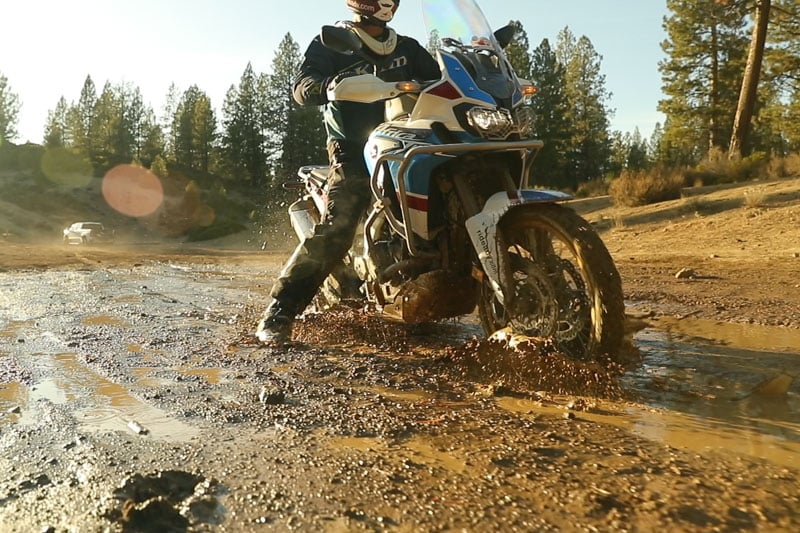 Eric laying down a dab while crossing a muddy portion of the trail