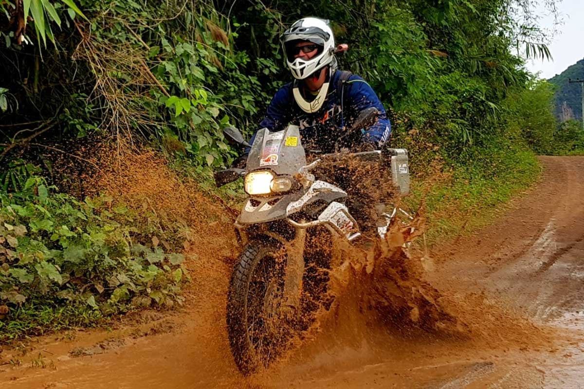 Eric testing out the durability of his adventure gear by riding through a muddy river. 
