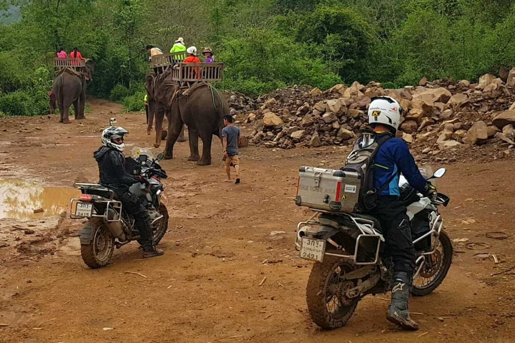 Eric in Thailand riding by an elephant while wearing the tech 10's.