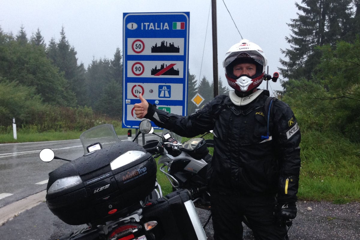 Eric crossing the boarding into Italy on his adventure motorcycle.