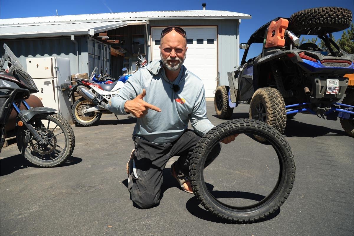 eric-with-a-tire-in-front-of-our-motorcycle-shop