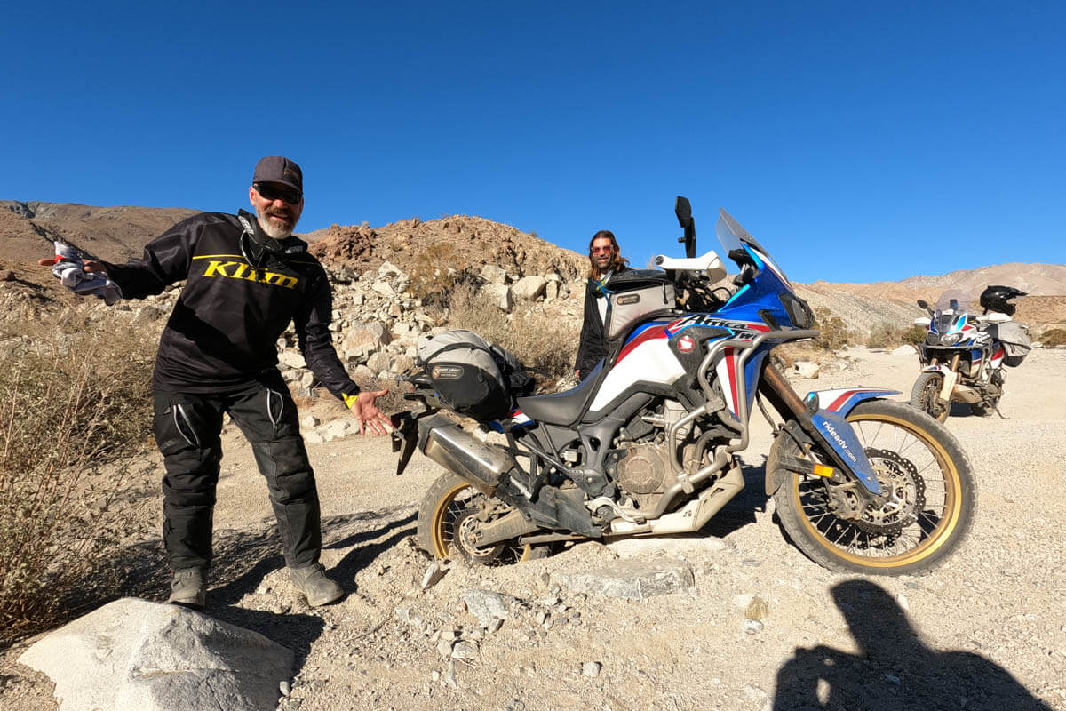 Scott and the crew with his motorcycle stuck in the gravel while out riding in the Sierras Mountains.