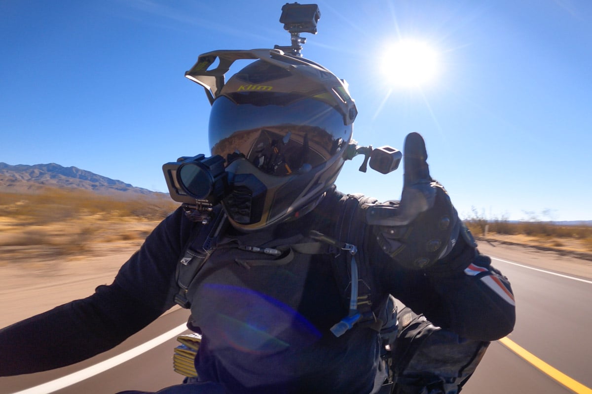 Garrett giving a thumbs up while riding down the highway.