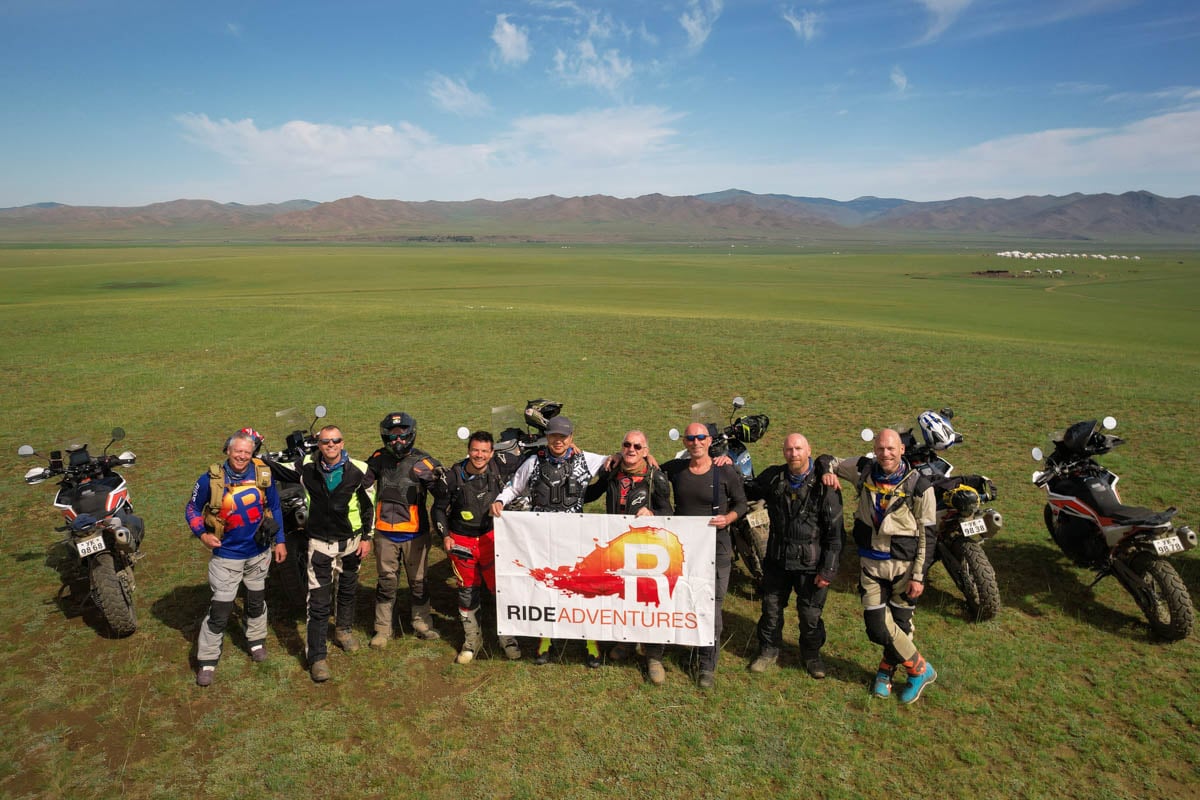 happy customers group pic with logo ride banner
