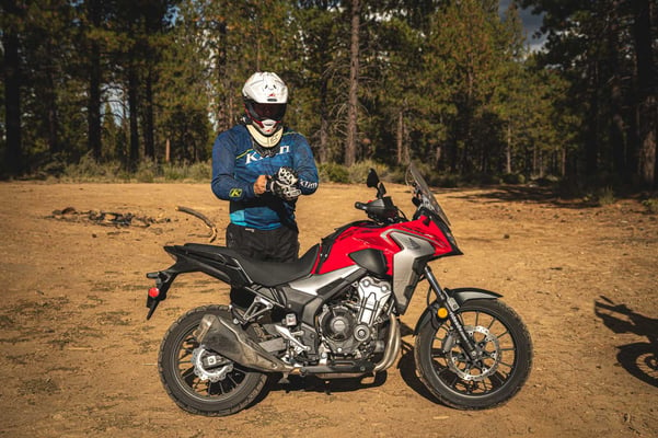 Rider putting on gloves in front of the Honda Cb500x