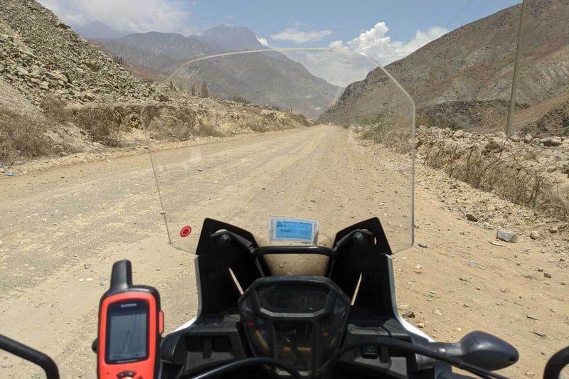 Adv rider taking a break on the side of the road.