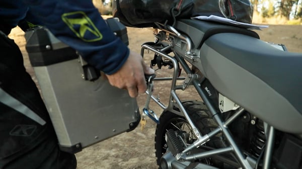 Eric installs a hard motorcycle case as an example of how heavy it can be