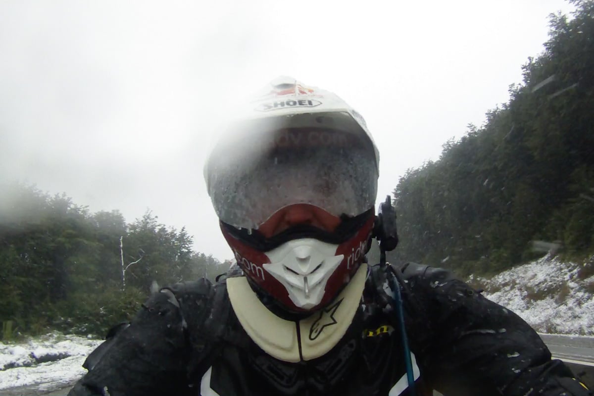 Eric getting pounded by snow and sleet right before riding into Ushuaia.