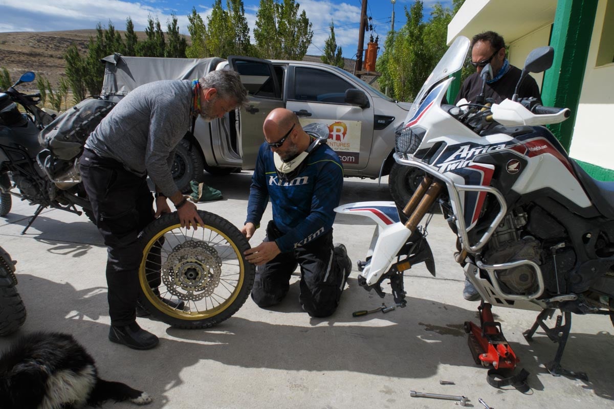 Eric doing some repair work on the ground putting Klim's Badlands pro pants to the test.