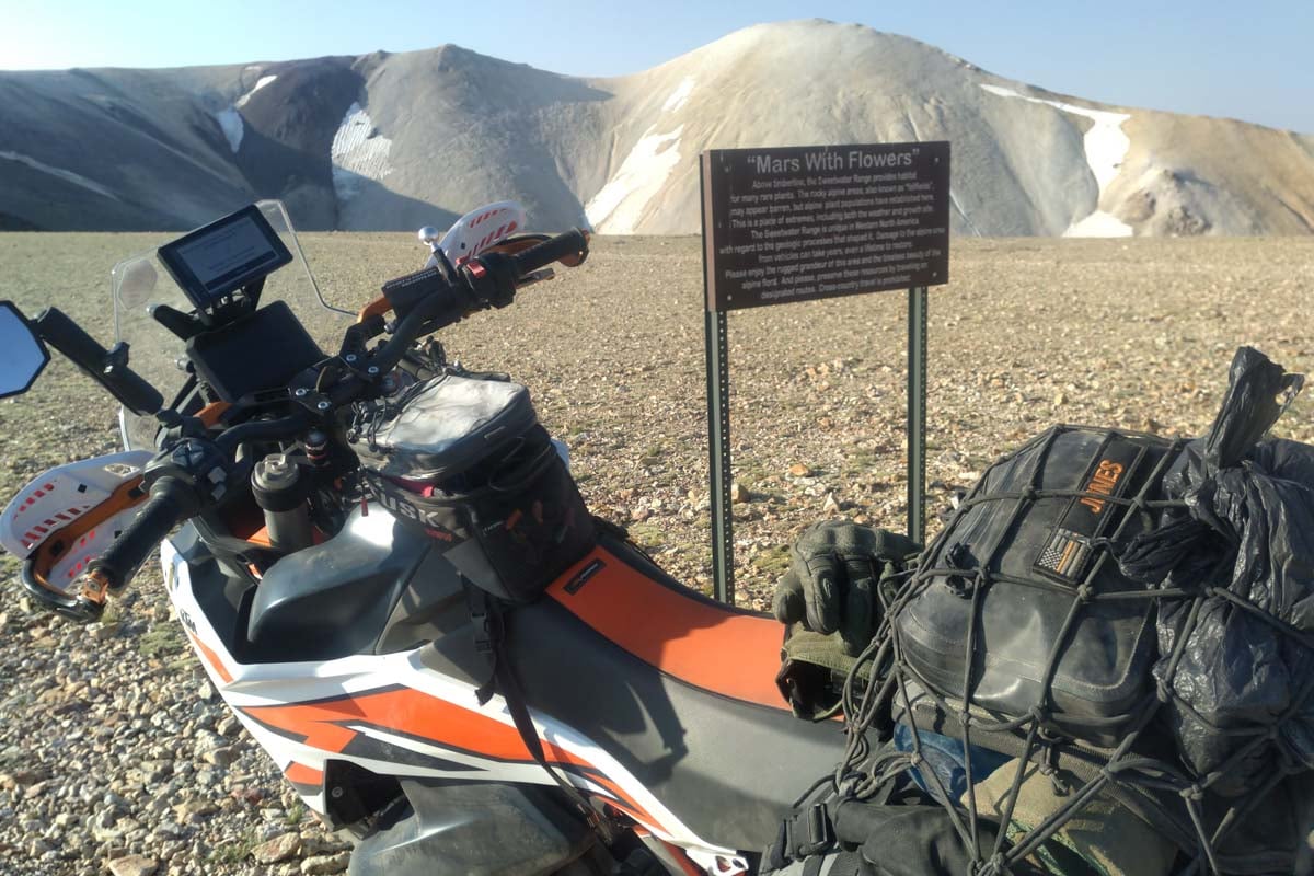 ktm 890 adventure in front of mars with flowers sign with mountains in background Oregon or Norcal BDR 