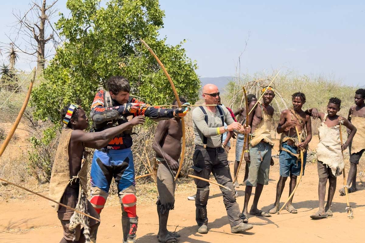 learning-to-shoot-an-arrow-with-the-hazabe-tribe-while-on-a-motorcycle-safari-tanzania-africa