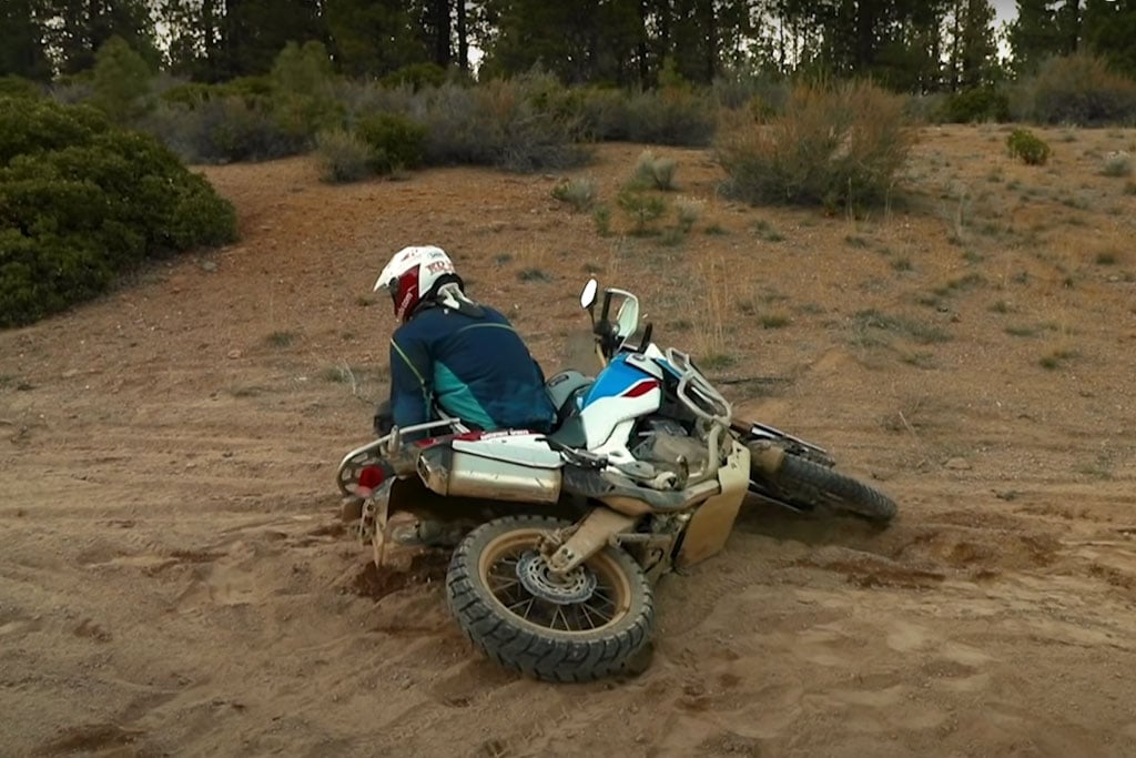 Eric showing how to lift with your legs when picking up a motorcycle.