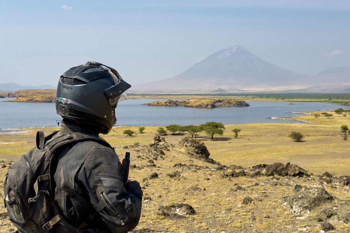 motorcycle-safari-rider-gazing-at-volcano-lengai-tanzania-africa