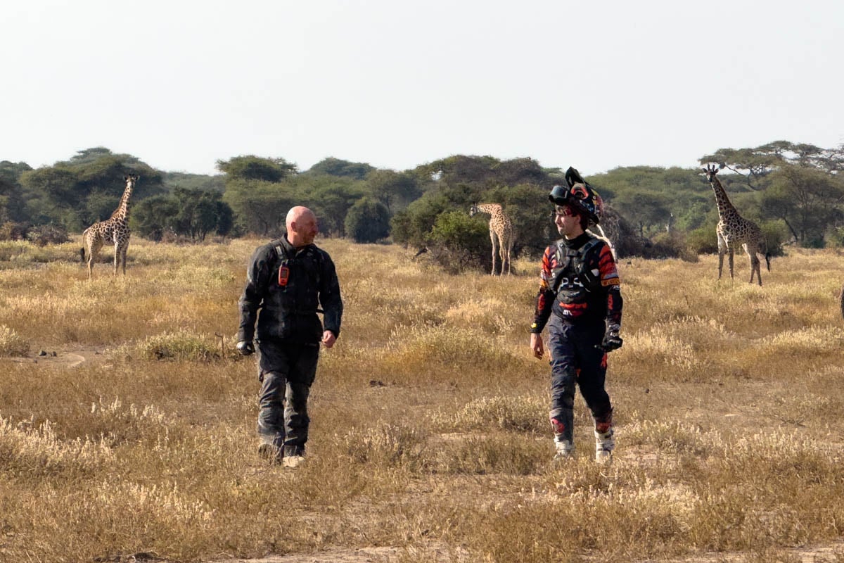 motorcycle-safari-riders-walk-amogst-giraffes-outside-tarangire-national-park-tanzania-africa