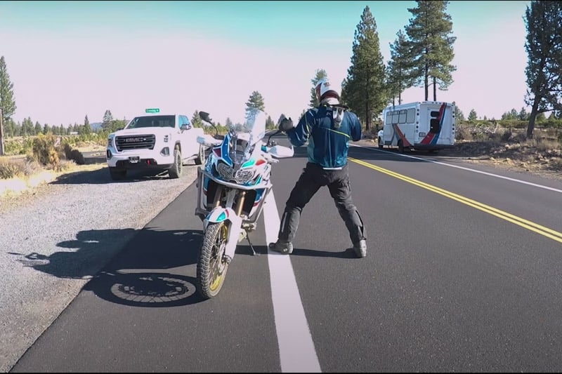 Eric getting off the bike the wrong way into oncoming traffic..