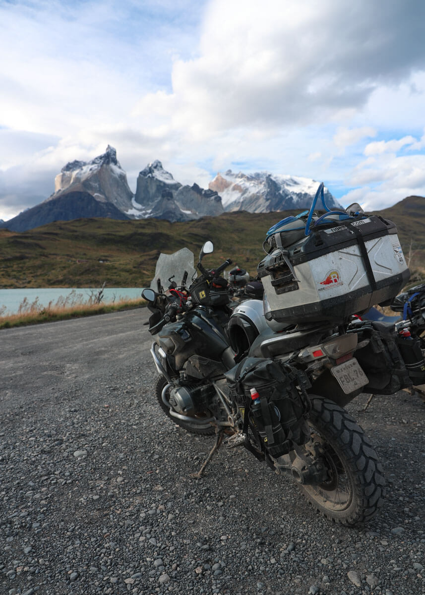 A motorcycle equiped with the Mitas E-07 Adventure Motorcycle tires with a backdrop of Patagonia's famous Torres Del Paine