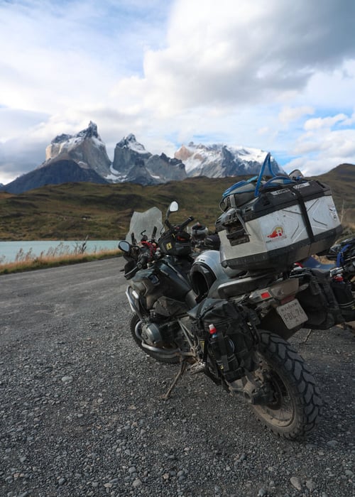 A motorcycle equiped with the Mitas E-07 Adventure Motorcycle tires with a backdrop of Patagonia's famous Torres Del Paine