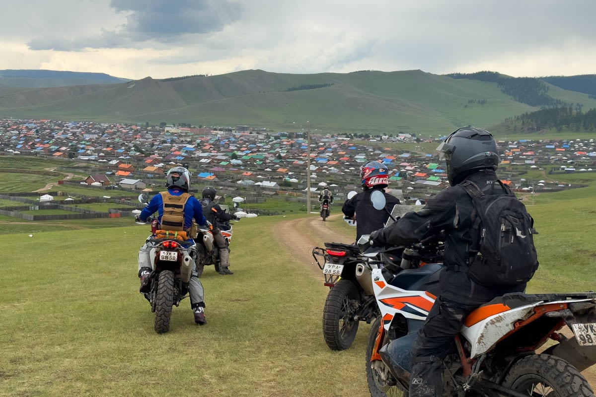 research crew overlooking a town somewhat lost 2
