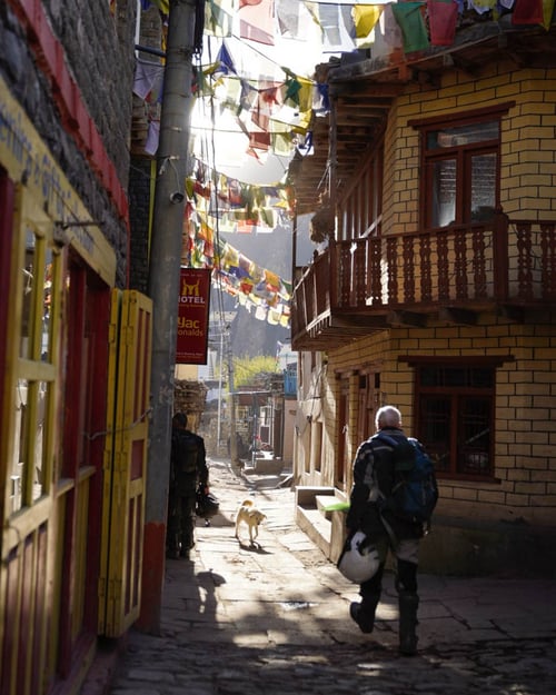 rider walks down the streets of kagbeni nepal