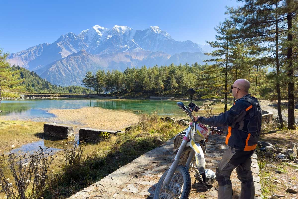 Rider admiring view of annapurna range himalayas while riding in a summer motorcycle jacket