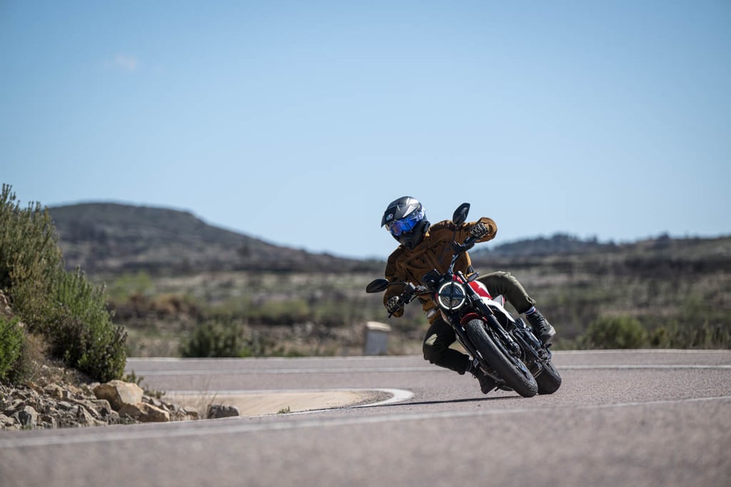 rider-cornering-will-wearing-the-agv-ax9-carbon-helmet