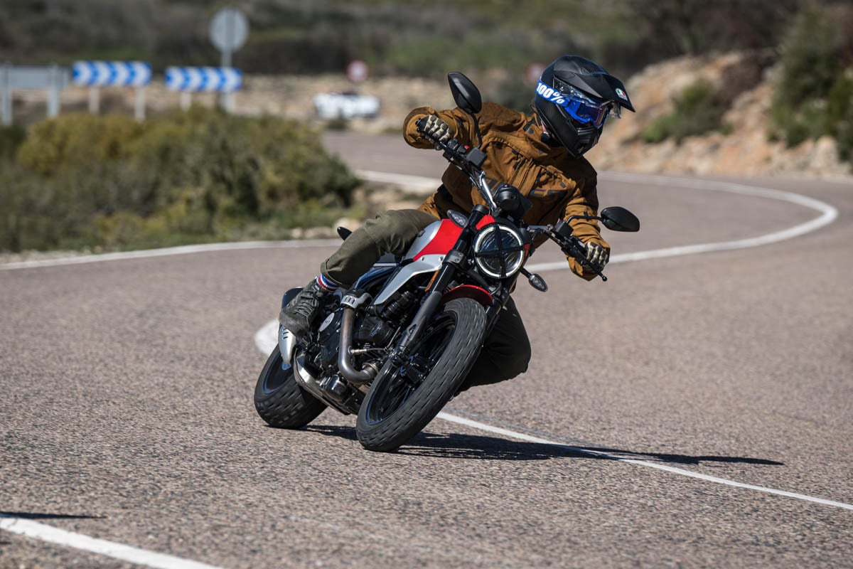 rider-on-scrambler-cornering-while-wearing-agv-ax9-carbon-helmet