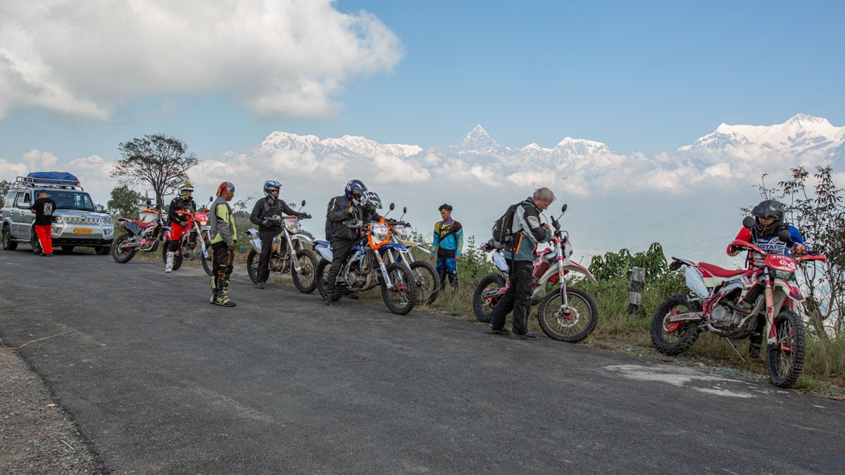 riders-and-support-truck-with-himalayas-in-background-nepal