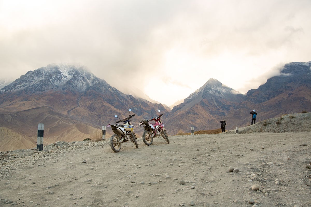 riders-looking-at-mountains-on-side-of-trail-nepal.jpg