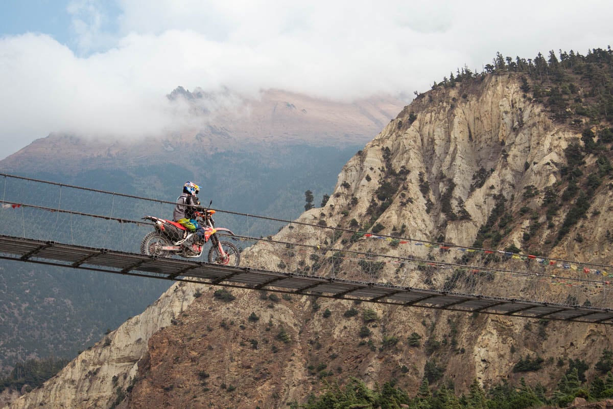 suspension-bridge-rider-mountain-background-nepal