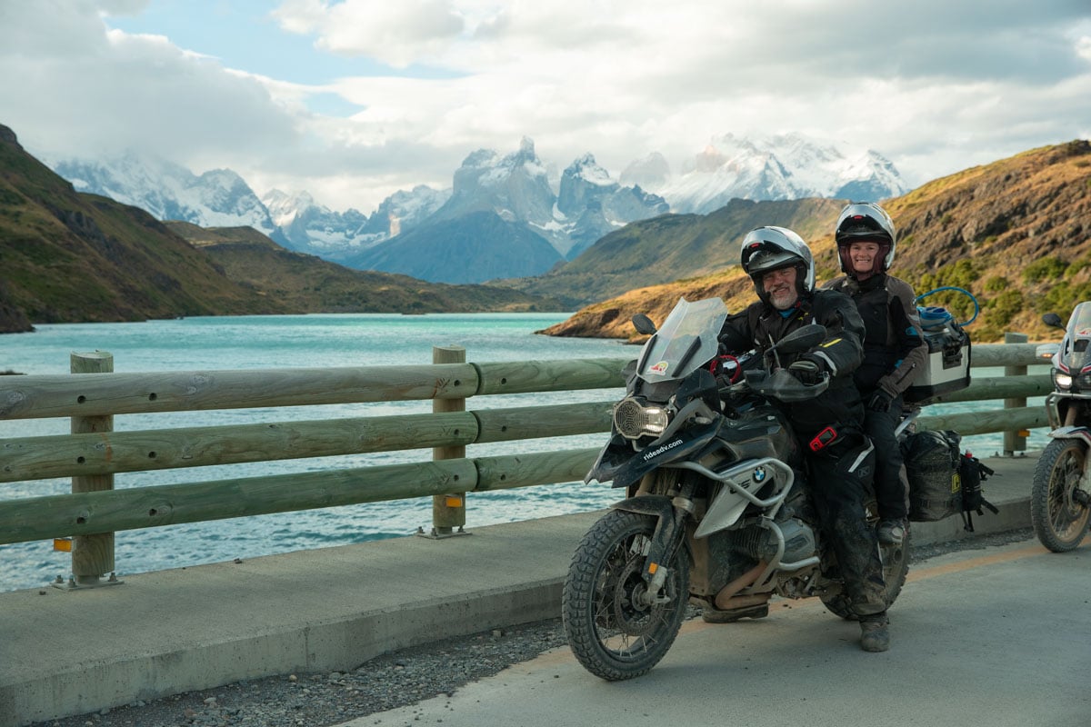 two up riders smiling with views of patagonia behind them