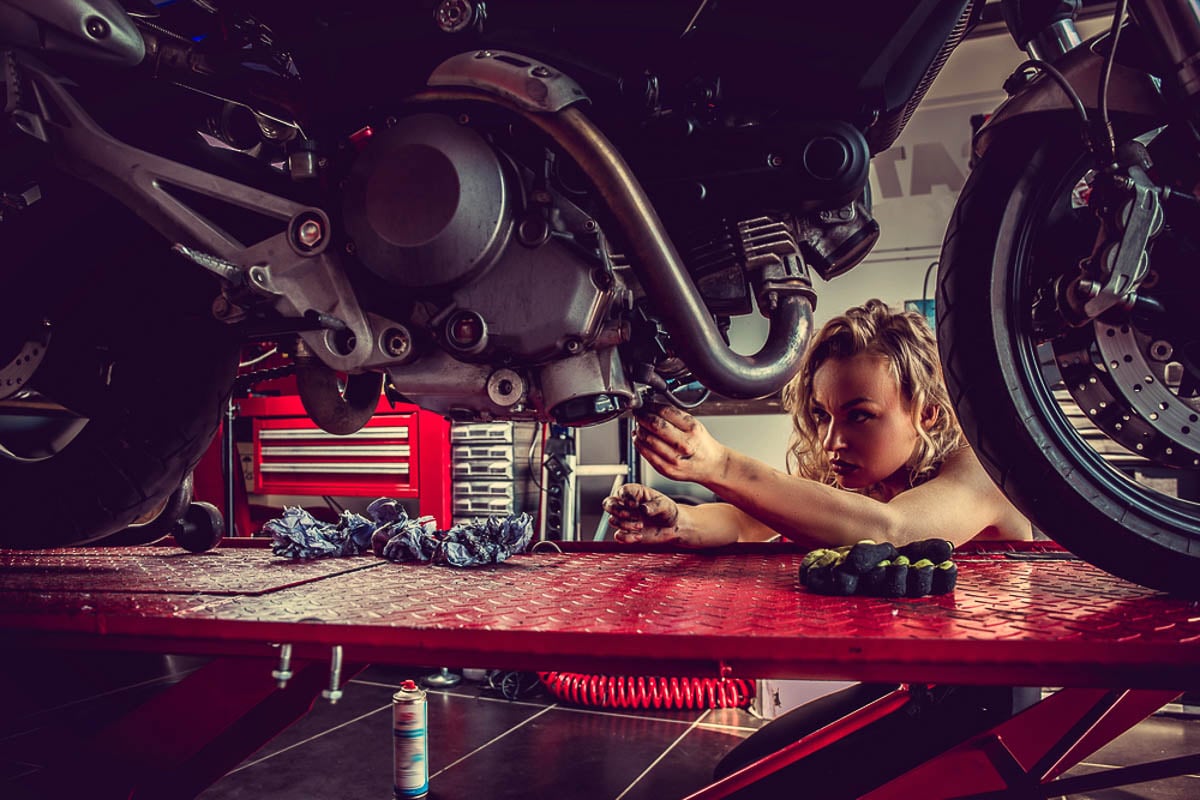 woman fixing motorcycle