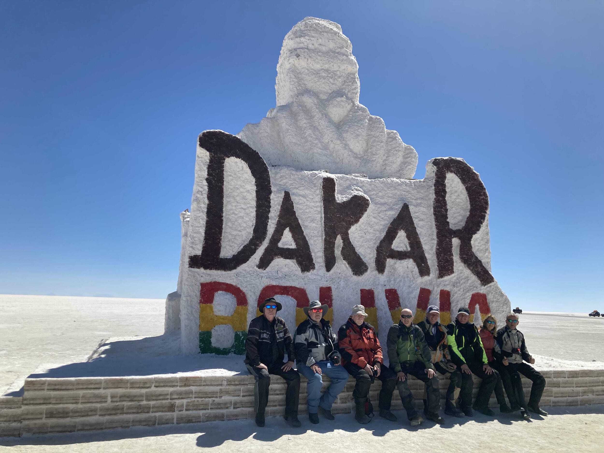ADV riders in front of Dakar Bolivia Sign near salt desert