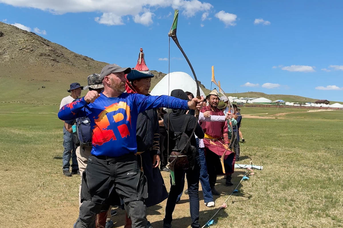 charles trying archery with the mongolians at the nadaam festival